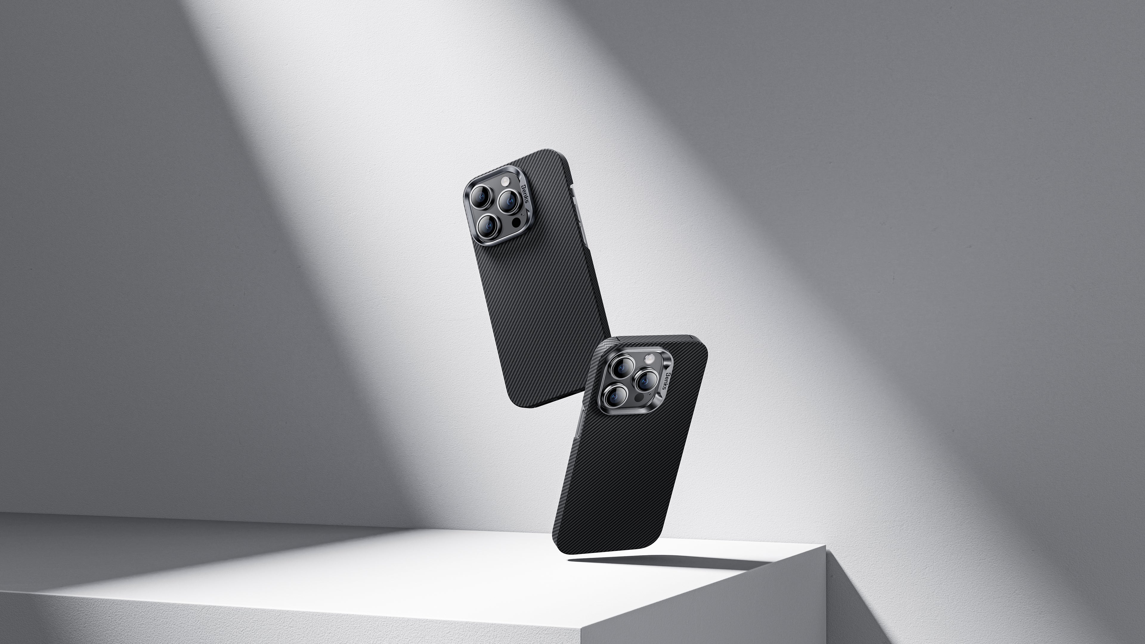 Two black iPhone 16 cases displayed in a sleek, minimalistic environment. The image emphasizes design updates and highlights potential leaks about the new features of the upcoming iPhone 16, reflecting the latest trends and technological advancements.